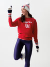 Smiling model in a red apres ski sweatshirt