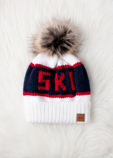 White, red, and navy pom pom hat 