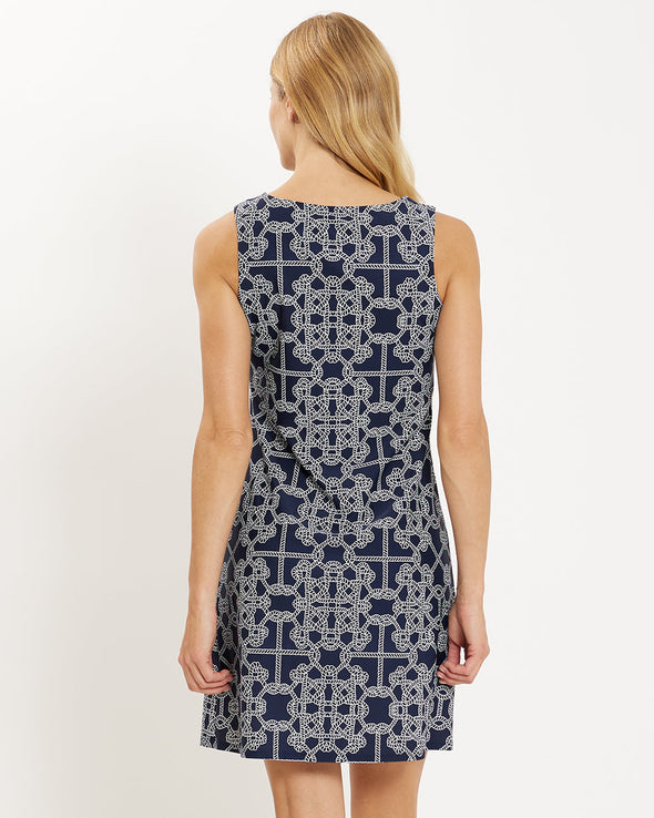 Back of model wearing navy and white rope print sleeveless dress