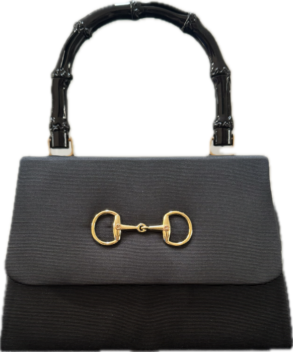 Black faille purse with gold snaffle embellishment on the flap and a black bamboo handle