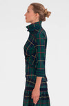 Side view of the GS Twist and Shout top. Woman in a green plaid top with a popped collar