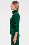 Side view of model in the Gretchen Scott Twist & Shout Top - Silky Velvet - Green