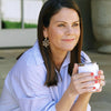 Smiling model with cup in her hands wearing the Susan Shaw Coral Branch Earrings