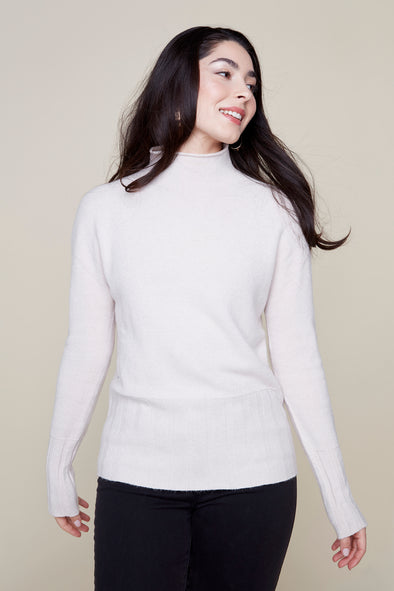 Smiling model in white mock neck Renuar sweater