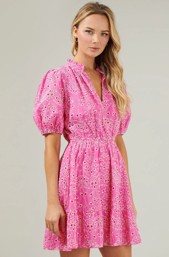 Blonde model wearing pink eyelet lace puff sleeve dress